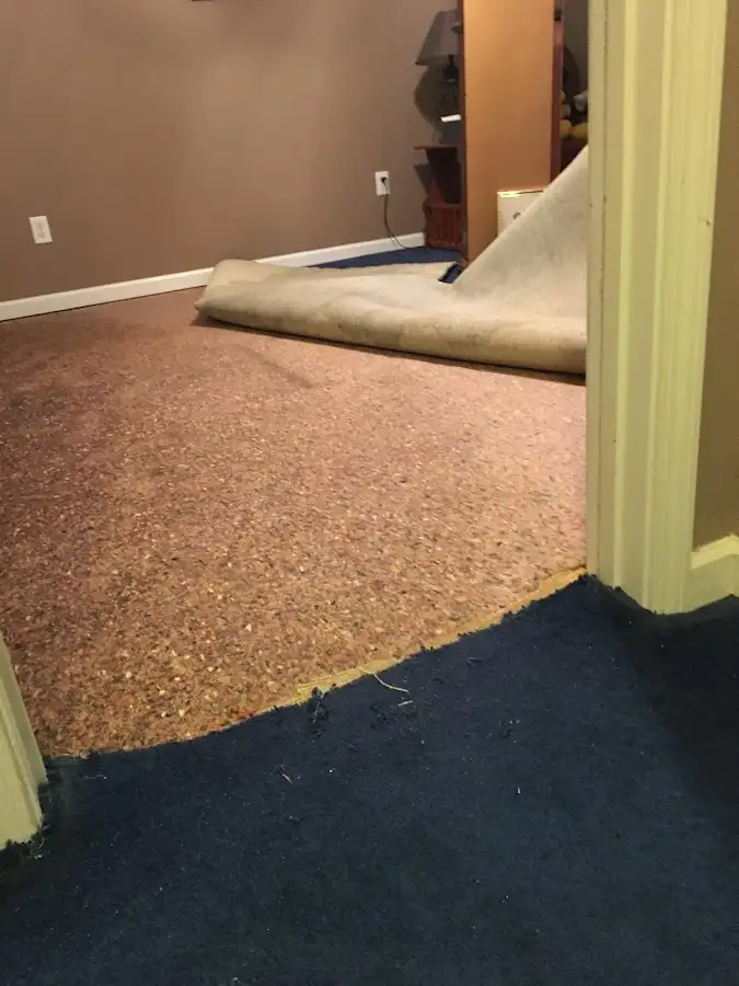 Carpet pad removal revealing water damage during Drying & Dehumidification in Macedon